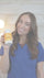 Woman holding a supplement bottle with a blurred background