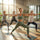 Group of women practicing yoga in a bright, sunlit studio.